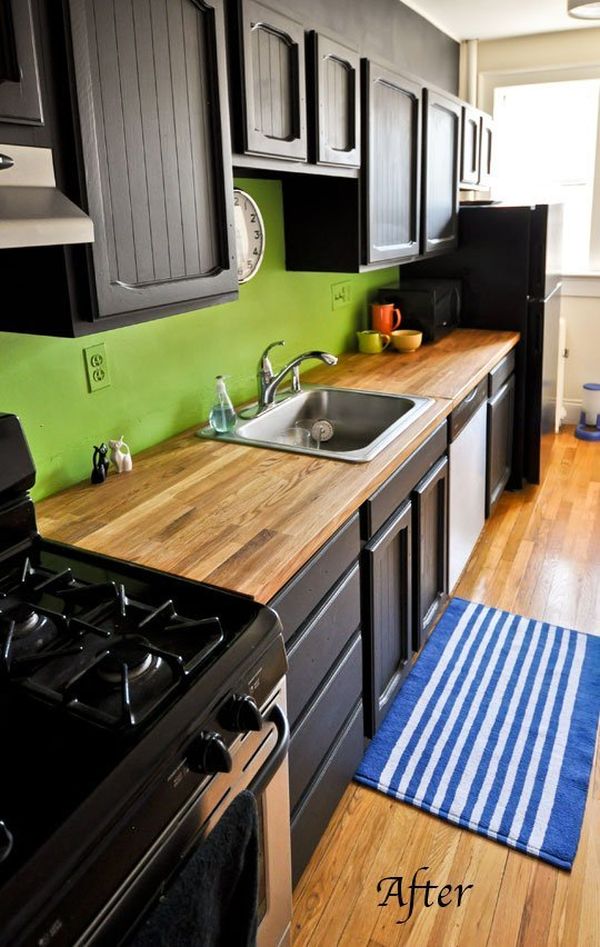 black cabinets with green backsplash