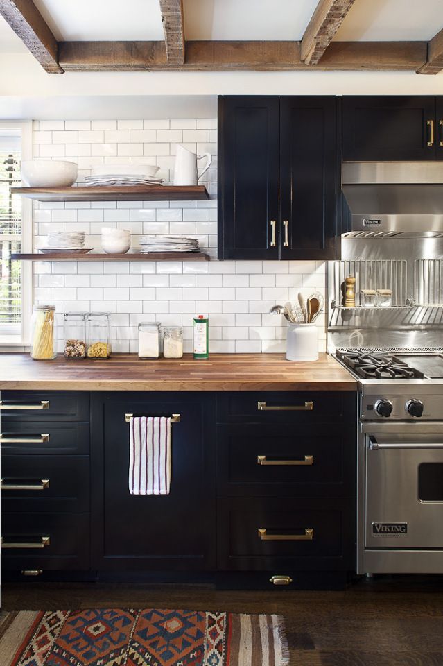 Rustic black kitchen cabinets subway white tiles