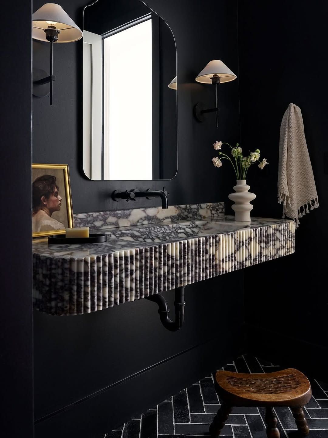 Dark Powder Room with Textured Marble Vanity