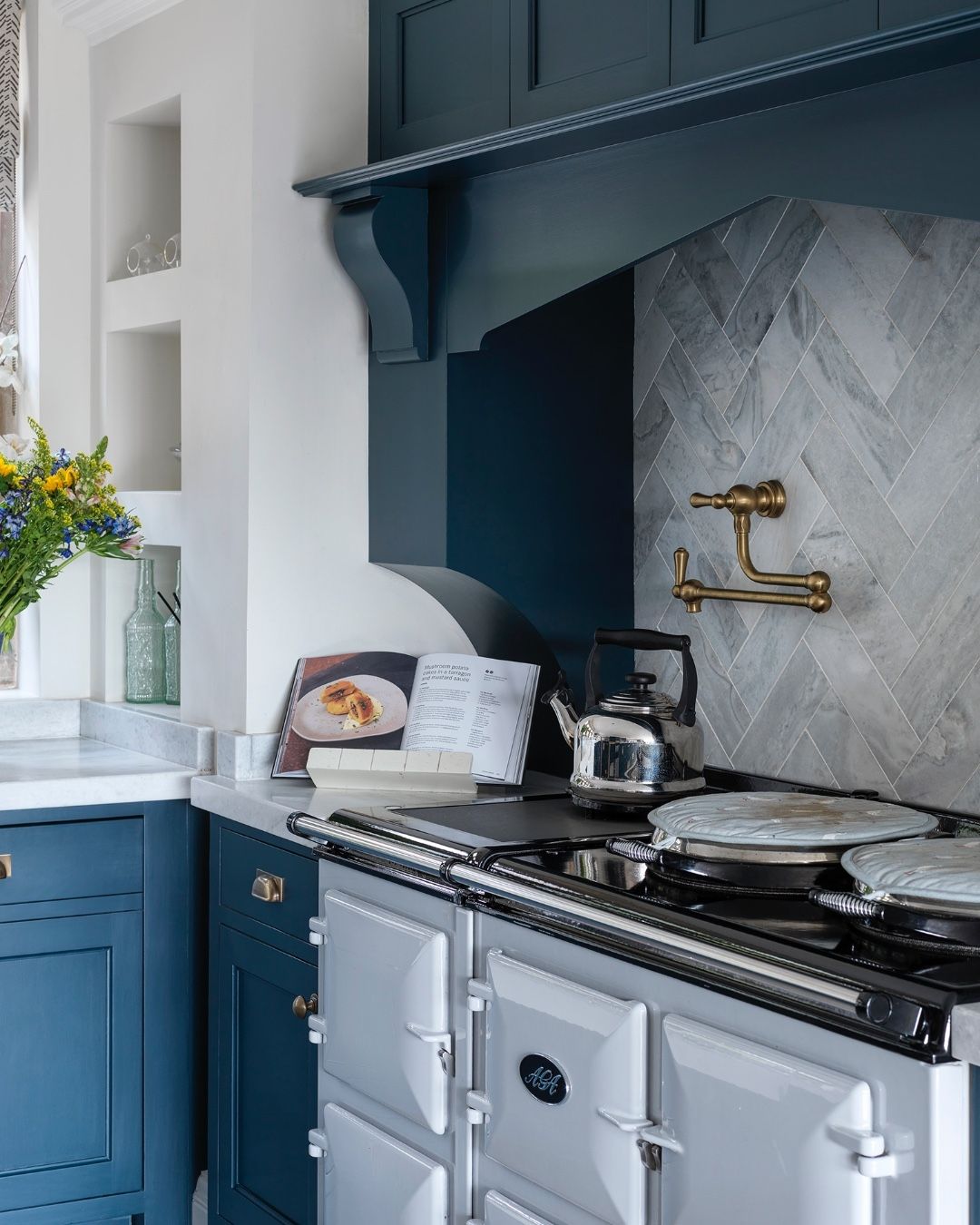 Deep Blue Cabinetry With Brass Pot Filler