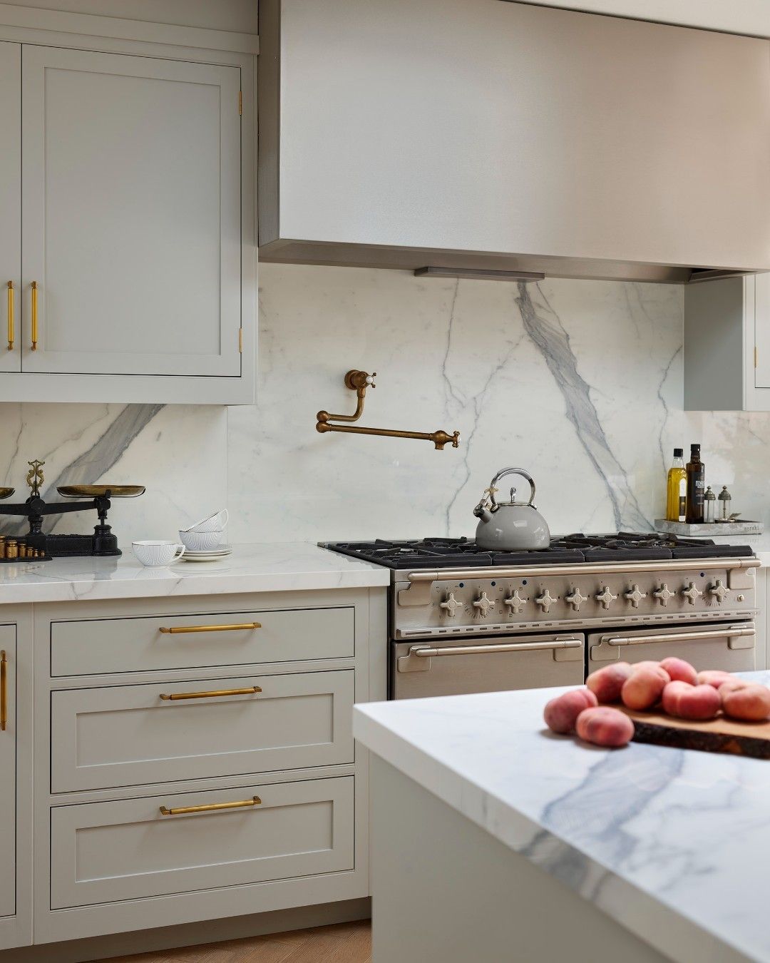 Marble Slab Backsplash With Sleek Brass Pot Filler