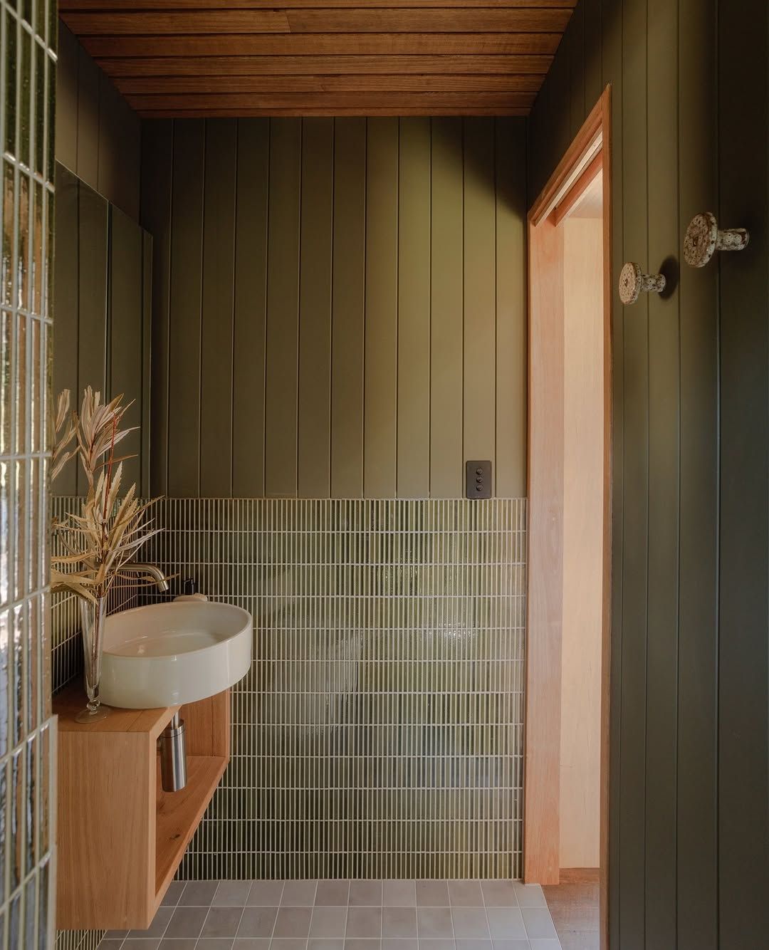 Narrow Olive Tiles With Wood Paneling